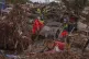Emergency services remove cars in an area affected by floods