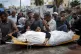 Palestinian women mourn a relative killed in the Israeli bom