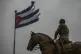 A Cuban flag shredded by the winds of Hurricane Rafael flies