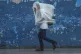 A man walks through the wind and rain brought by Hurricane R