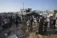 Palestinians gather at the site of an Israeli strike in the 