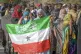 A woman displays the Somaliland flag as people queue to cast