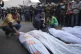 Palestinians mourn their relatives killed by the Israeli bom