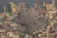 Smoke rises between buildings after an Israeli airstrike in 