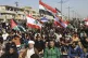 Followers of Shiite cleric Muqtada al-Sadr chant slogans whi