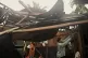 A resident checks belongings from his damaged home that was 