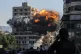 Smoke and flames erupt from a building hit in an Israeli air