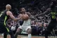 LA Clippers guard Kevin Porter Jr. (centre) tries to drive b