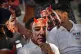 Participants wear paper masks in the likeness of Amazon's Je