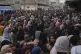 Palestinians gather to get food at a distribution center in 