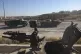 Opposition fighters ride military vehicles seized from the S