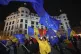 People wave Romanian and European Union flags during a pro-E