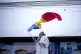 A man waves the Romanian flag outside the closed voting stat