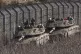 Israeli soldiers sit on top of a tank along the so-called Al