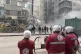 Rescuers search through the rubble of a collapsed six-story 