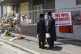 People gather outside the fire damaged Adass Israel Synagogu