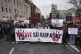 People hold a banner that reads “You have blood on your ha