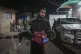 A dead child is carried into the Al-Aqsa Martyrs hospital in