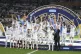 Real Madrid's players celebrate with the trophy after winnin