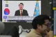 A TV screen shows a file image of South Korean President Yoo