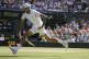 Australia's Nick Kyrgios returns the ball from between his l