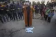 Imam Islam Abu Suaied prays over the bodies of two babies be