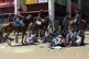 Police on horses surround people during protests against abd