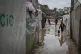 Palestinian children carry buckets of water after overnight 