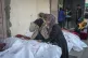 Relatives mourn over the bodies of victims of overnight Isra