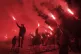 Children light torches during a protest demanding the resign