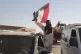 A Sudanese man gestures waving a Sudan flag following the re