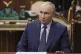 Russian President Vladimir Putin listens to the CEO of the R