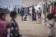 Palestinian children play at a tent camp for displaced Pales