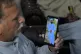 A Pakistani Mohammad Akram shows a picture of his son Abu Ba