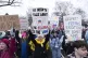 Demonstrators hold signs as they protest President-elect Don
