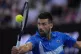 Novak Djokovic of Serbia returns a ball from Jiri Lehecka of
