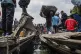 People fleeing M-23 rebel advances arrive by boat in Goma, D