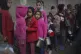 Palestinian children queue at a food distribution kitchen in