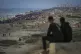 Two boys watch a crowd of Palestinians returning to northern