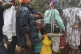People line up to receive food at a shelter for families dis