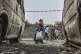 Residents walk by charred vehicles in Goma, Democratic repub
