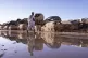 A man walks past stacked up cars after floods in Catarroja t