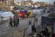 People move along a road amid widespread destruction caused 