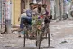 People carry an injured protester in a cycle rickshaw to a h