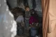 Qasim Al-Najjar, 4, stands inside a wrecked classroom in the