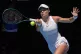 Emma Raducanu of Britain plays a forehand return to Iga Swia