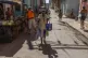 An elderly woman walks with the aid of a cane in Old Havana,
