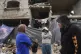 Members of the Tambora family stand outside their four-story