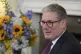 Britain's Prime Minster Keir Starmer speaks to guests as he 