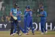 England's Jos Buttler (left) walks off the field as Afghanis